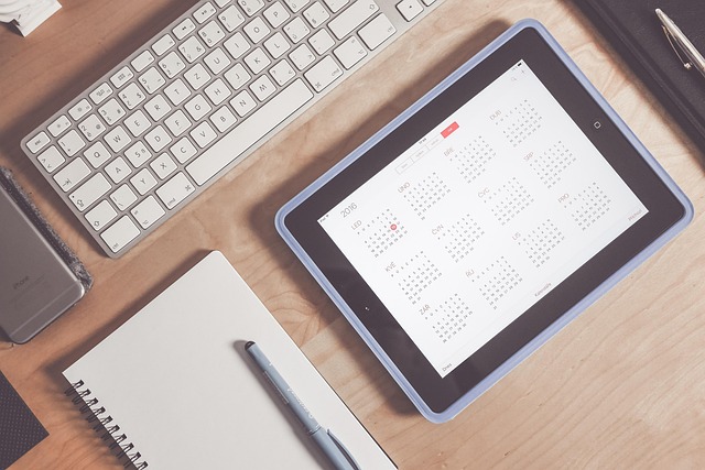 modern productivity planning with calendar and laptop in dark workspace