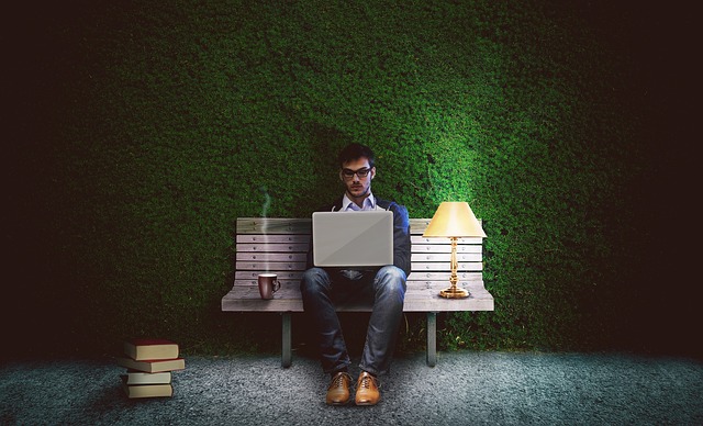 focused ambitious person reading self improvement article on laptop at night